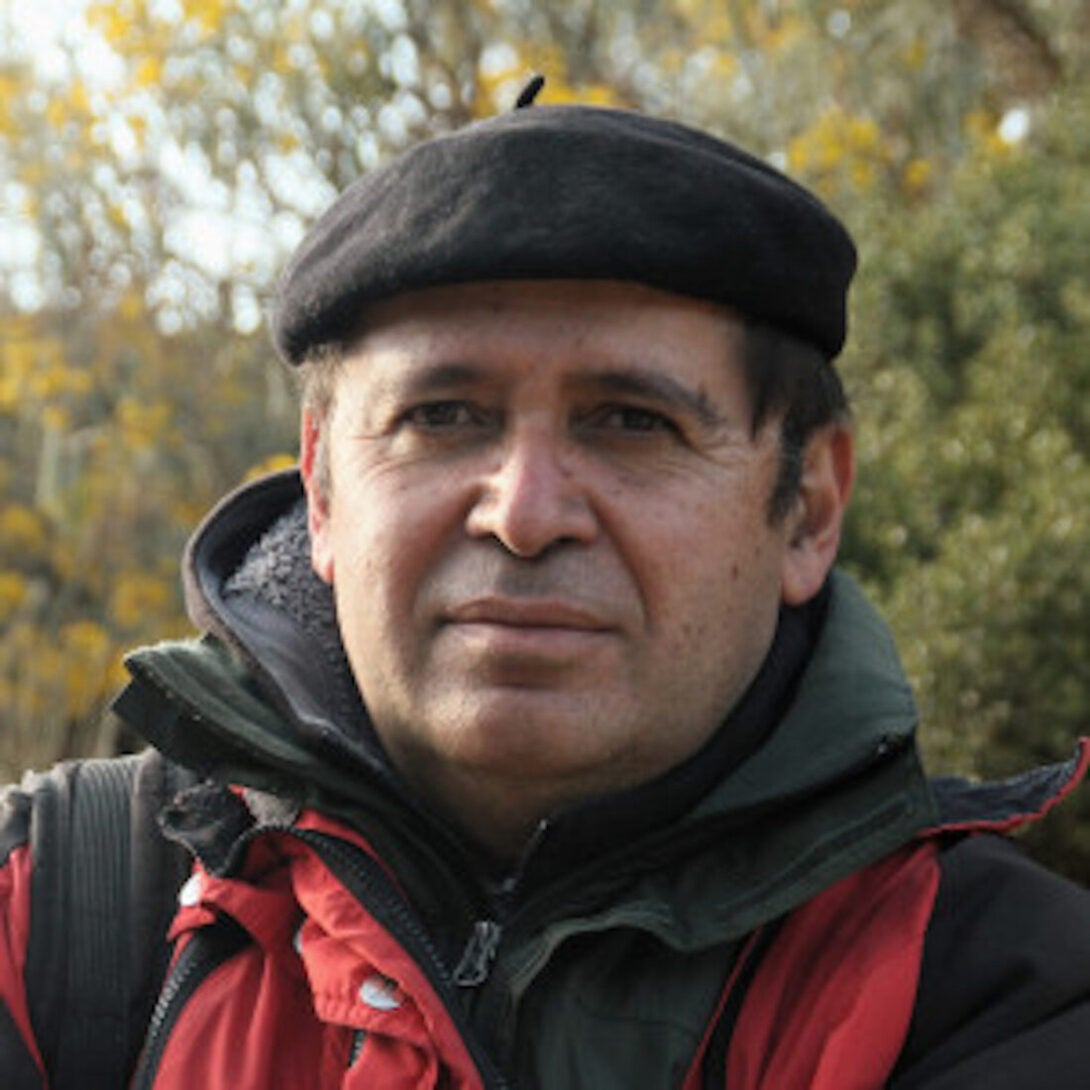 man standing in front of a camera in a field